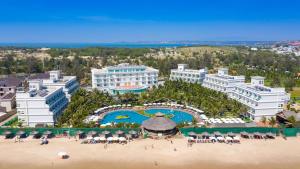 an aerial view of a resort with a beach at The Sailing Bay Beach Resort in Mui Ne