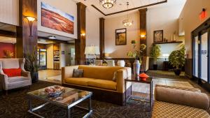 a lobby with a couch and chairs and a table at Best Western Plus Layton Park Hotel in Layton