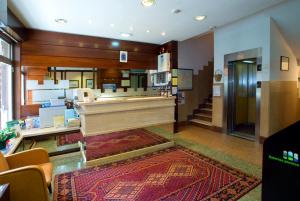 a large room with a piano and a staircase at Hotel Castilla in Gijón