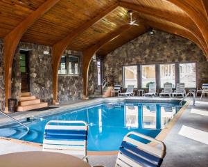 ein Pool in einem Haus mit Stühlen um ihn herum in der Unterkunft Econo Lodge in Wooster