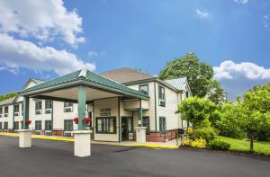 a large white building with a gazebo at Econo Lodge Glens Falls - Lake George in Glens Falls