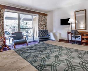 a hotel room with a large bed and a balcony at Econo Lodge Near Reno-Sparks Convention Center in Reno