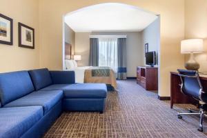a hotel room with a couch and a bed at Comfort Inn & Suites Norman near University in Norman