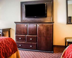 a hotel room with a flat screen tv on a dresser at Quality Inn & Suites Roswell in Roswell