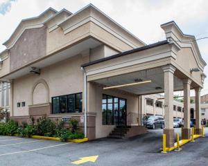 a building with a parking lot in front of it at Rodeway Inn in Paterson