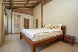 a bedroom with a large bed in a room at Villa Coral in Pemuteran