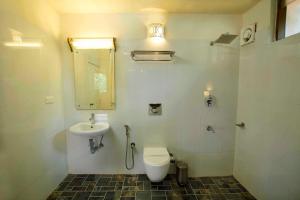 a bathroom with a toilet and a sink at Coffee Routes in Thekkady +35 photos