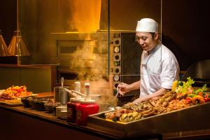 a chef preparing food in a restaurant kitchen at JEN Penang Georgetown by Shangri-La in George Town +100 photos