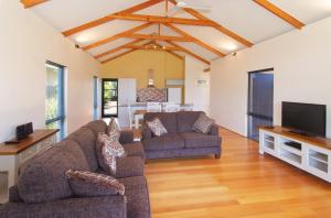 a living room with two couches and a flat screen tv at Beechtree in Dunsborough