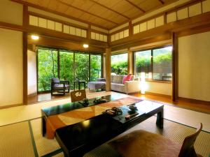 a living room with a table and a couch at Midoriso in Hioki