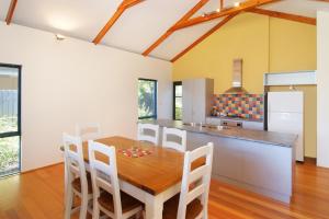a kitchen and dining room with a wooden table and chairs at Beechtree in Dunsborough