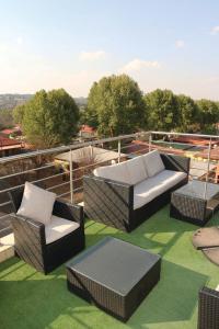 a patio with chairs and couches on a roof at Garden Top Hotel in Johannesburg