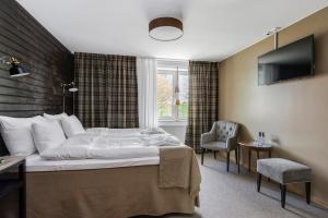 Säng eller sängar i ett rum på Dömle Herrgård Spa & Resort