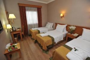 מיטה או מיטות בחדר ב-Usta Park Hotel