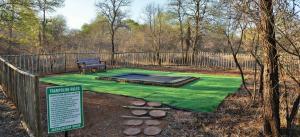 a park with a picnic table and a green lawn at Jackalberry Ridge by Dream Resorts in Marloth Park