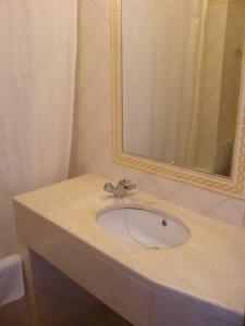 a bathroom with a sink and a mirror at Hotel Passagem do Sol in Moura