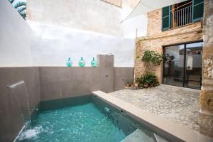 a swimming pool in the middle of a house at Vila Roja, design townhouse in Alcúdia in Alcudia