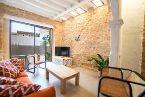 a living room with a couch and a table at Vila Roja, design townhouse in Alcúdia in Alcudia
