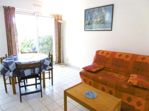 a living room with a couch and a table at Appartment Erwan in Arzon