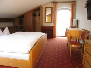 Un pat sau paturi într-o cameră la Hotel Bräukeller