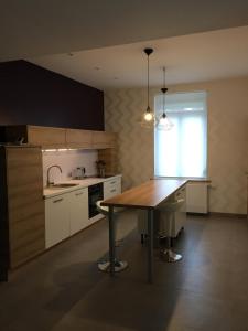 a kitchen with a wooden table and a sink at La '1923' in Locon