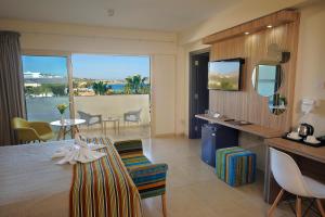 a living room with a view of the ocean at Nelia Beach Hotel & Spa in Ayia Napa