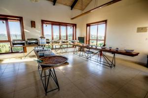 a room with tables and chairs in a room with windows at Ajloun Forest Reserve in Ajloun