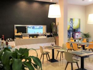 a restaurant with tables, chairs and tables at Apartamentos Plaza Picasso in Valencia
