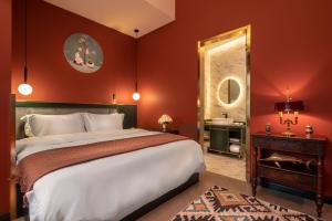 a bedroom with a large bed and a mirror at Moon and Chalice Boutique Hotel in Kunming