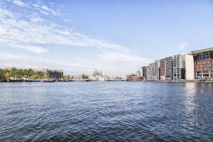 a large body of water with buildings and buildings at Felicitas in Amsterdam