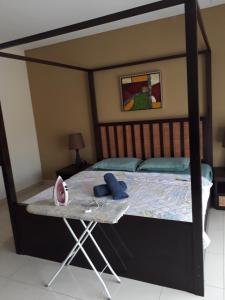 a canopy bed with a table in a bedroom at Gold Coast Morib Resort in Banting +9 photos