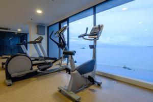 a room with a large window and a large flat screen tv at Tanjung Point Residences in George Town