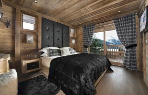 Ένα ή περισσότερα κρεβάτια σε δωμάτιο στο Les 3 Chalets Courchevel