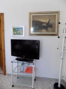 a flat screen tv sitting on a table in a room at Vi.Co House in La Maddalena