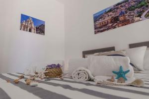 Una cama o camas en una habitación de MareinSicilia: Talia Residence