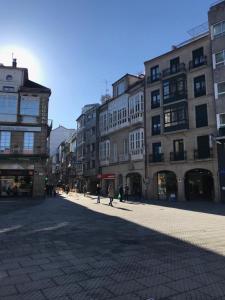 a city street with buildings and people walking on the street at APARTAMENTO Plaza de la Peregrina Pontevedra VUT-PO-03908 in Pontevedra