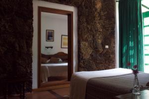 a mirror in a room with a bed and a bedroom at Hotel Ida Inés in Frontera