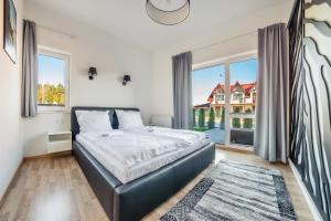 Posteľ alebo postele v izbe v ubytovaní Apartamenty Sun & Snow Seaside Grzybowo