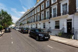 a black car parked on the side of a street at Veeve - Sloane Square Hideaway in London