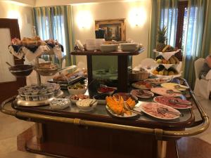 a buffet with many different types of food on a table at Foscari Palace in Venice