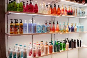 a shelf filled with lots of different colored glass bottles at WATER HOTEL Cy (Audlt Only) in Machida