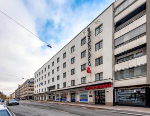 a large white building on a city street at Omena Hotel Turku Humalistonkatu in Turku