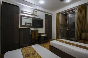 Postel nebo postele na pokoji v ubytování Hotel Sunstar Heights