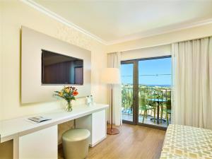 a hotel room with a bed and a tv at Hotel Baia Grande in Albufeira
