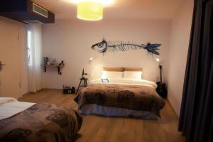 a bedroom with two beds and a fish on the wall at Rumours Inn in Istanbul