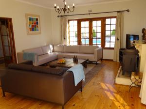 a living room with a couch and a table at The Gables in Hout Bay