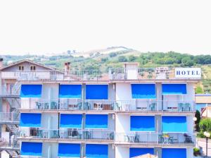 a building with blue balconies and a hotel at Hotel Mare Blu -- boutique in Pineto