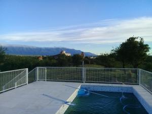a swimming pool on a patio with mountains in the background at La bendicion in Villa Cura Brochero