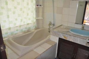 a bathroom with a tub and a sink at Surfside Boracay Resort in Boracay