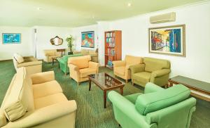 
a living room filled with furniture and a couch at Hotel Baia Grande in Albufeira
